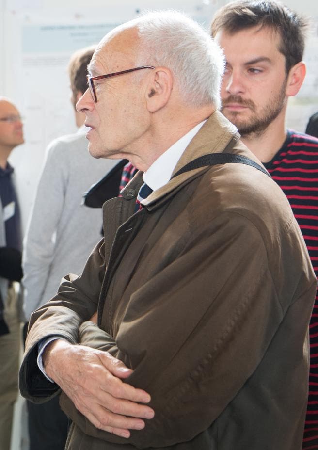 Henri B. Kagan seated at a microphone at an organic chemistry meeting at École Polytechnique in Palaiseau, France, 2013. Photo: École polytechnique, via Wikimedia Commons (CC BY-SA 2.0). Source page: https://commons.wikimedia.org/wiki/File:Henri_Kagan.jpg