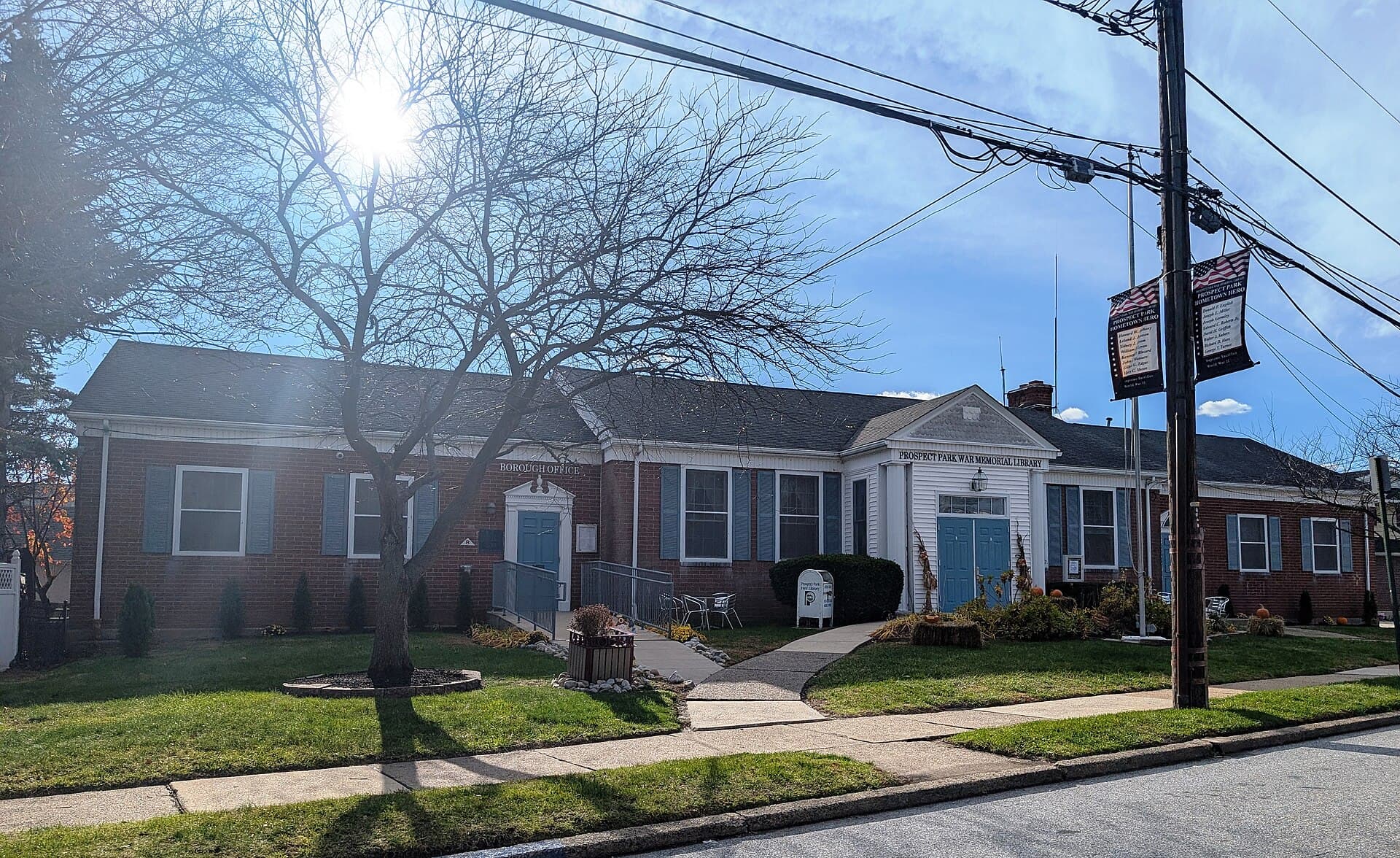 The single-story brick Prospect Park Borough Office and War Memorial Library on a sunny late-autumn morning, with bare trees and a lawn in front, Nov. 27, 2025. Illustrative image of the borough building where the rescuers were honored, taken before the event. Photo: Mr. Matté, CC BY-SA 4.0, via Wikimedia Commons. Source page: https://commons.wikimedia.org/wiki/File:Prospect_Park,_PA_Borough_Office_and_Library,_Nov._2025.jpg