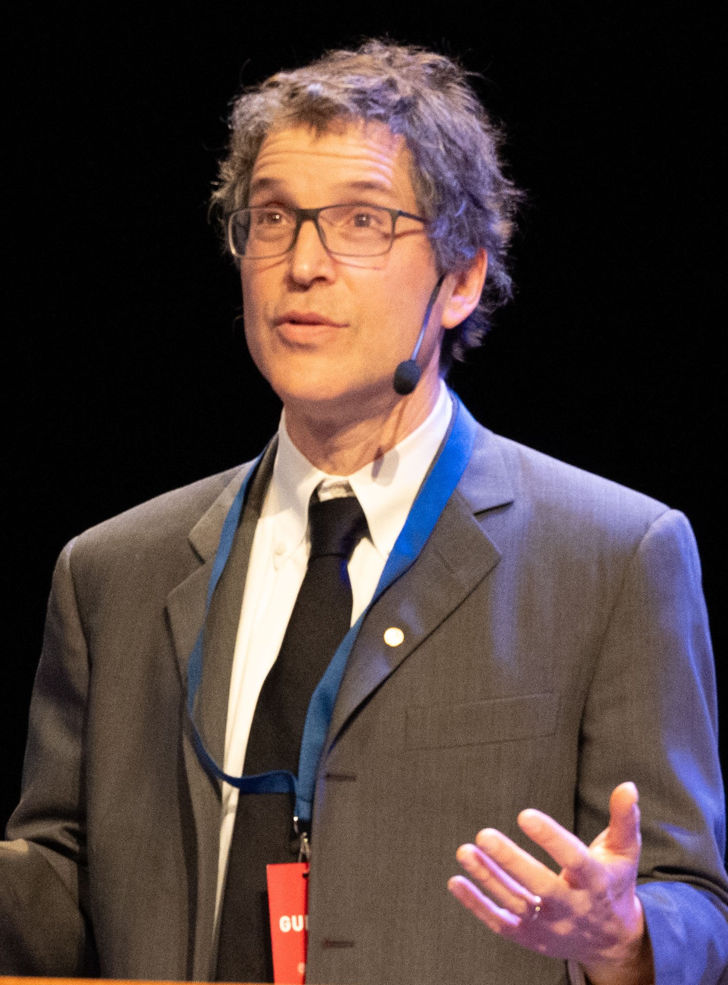 David Baker, wearing glasses and a dark jacket, at a press conference during Nobel Prize week in Stockholm.