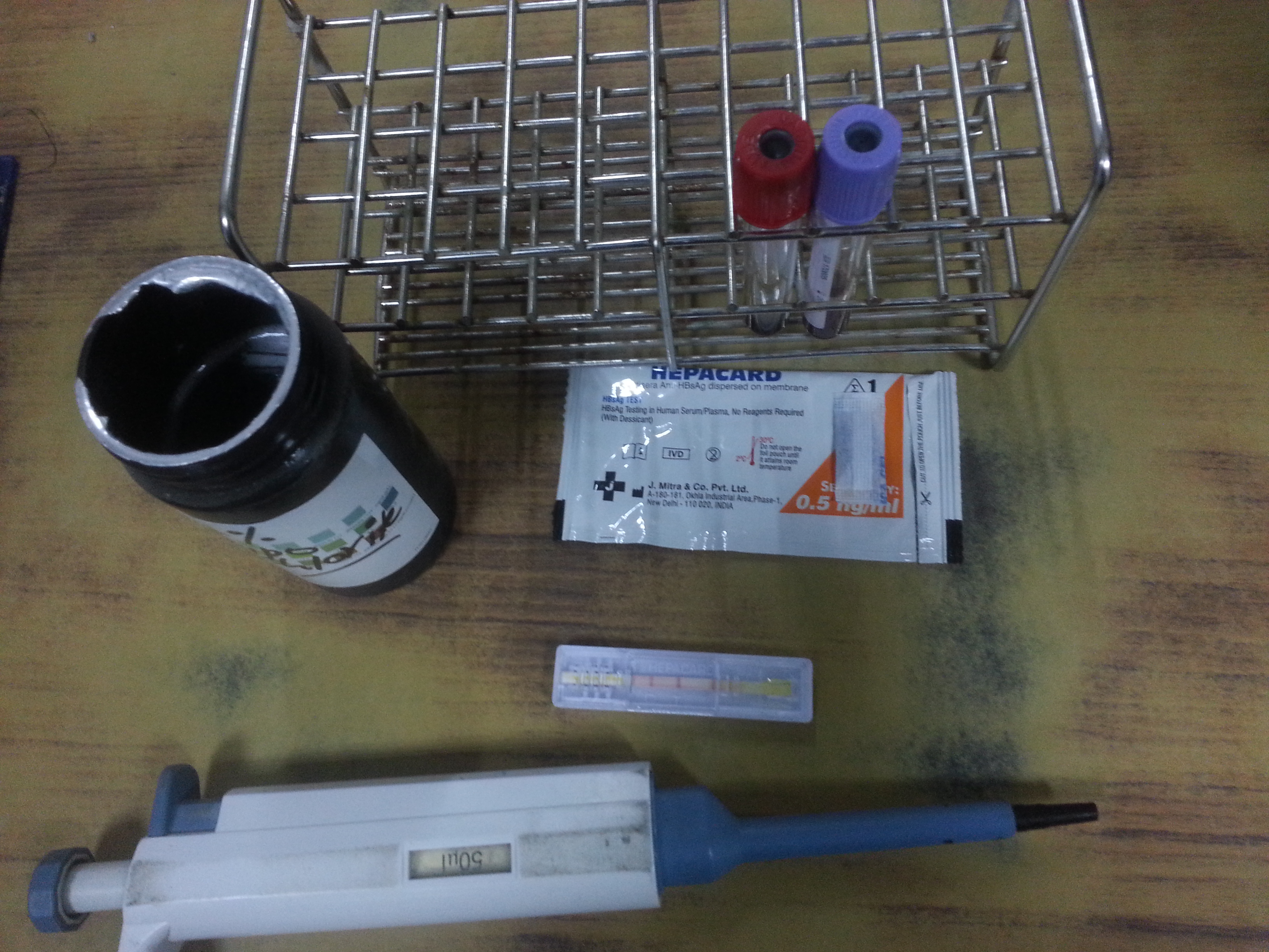 A rapid HBsAg test device showing a positive result.