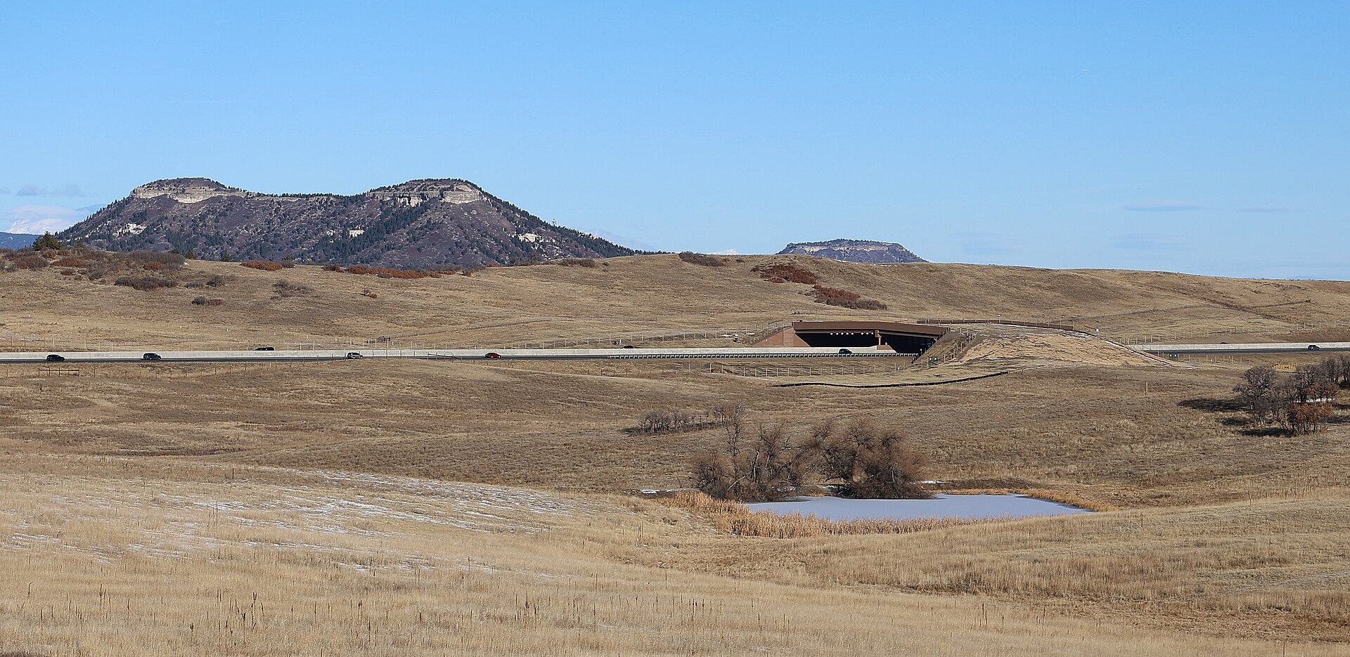 Wide view of the I-25 Greenland Wildlife Overpass and surrounding open space.