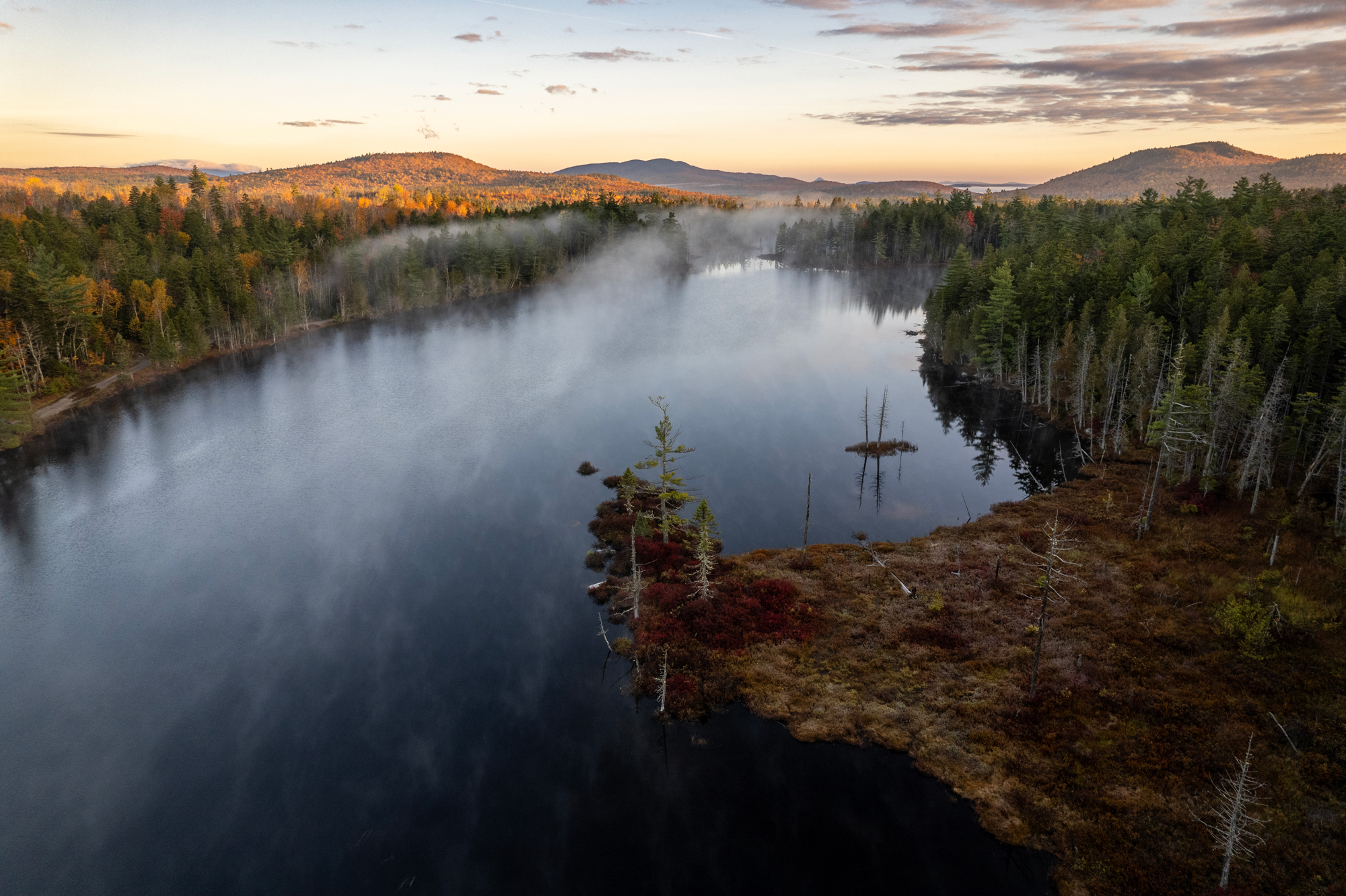 River and woodland along the Wáhsehtəkʷ landscape in Maine.