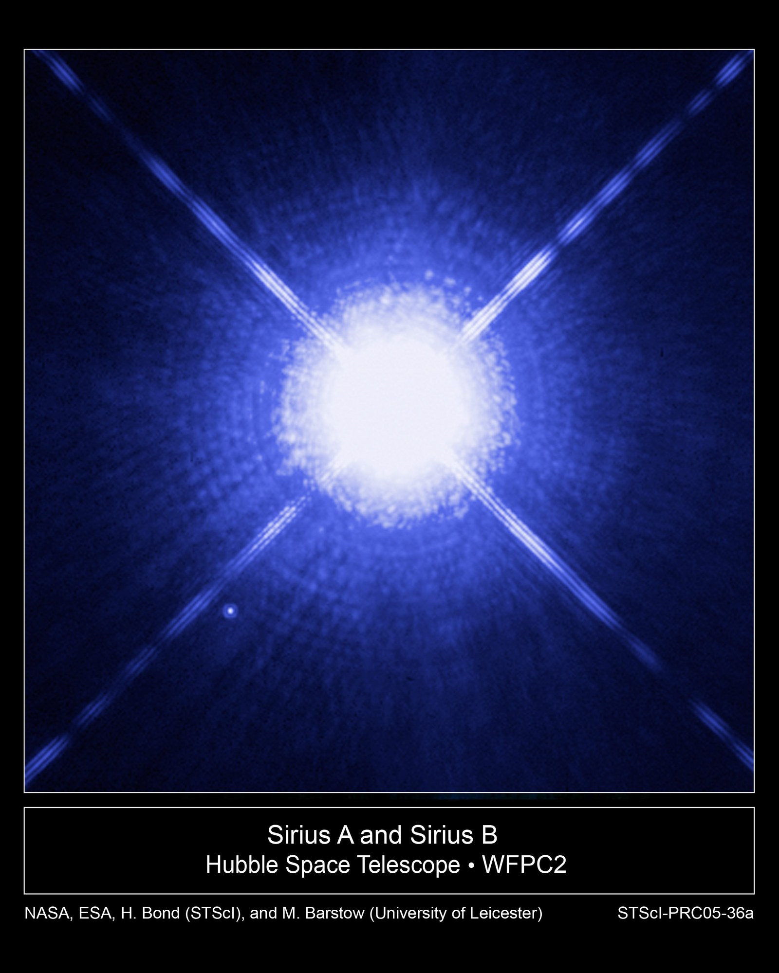 Hubble image of the bright star Sirius A with diffraction spikes and its faint companion white dwarf Sirius B as a small dot at lower left.